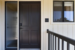 A black door with a number plate '664' and a window with a view of trees. - Napa Golf Course Condo - 2 King Suites + En-Suite Baths - Perfect for 2 couples (Napa)