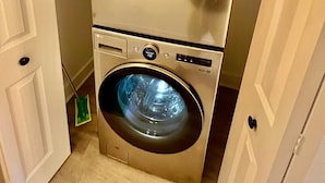 A compact, stainless steel LG washer and dryer unit with a digital display and a 'Quick Dry' button. - Luxury City Loft in Gainesville D (Gainesville)
