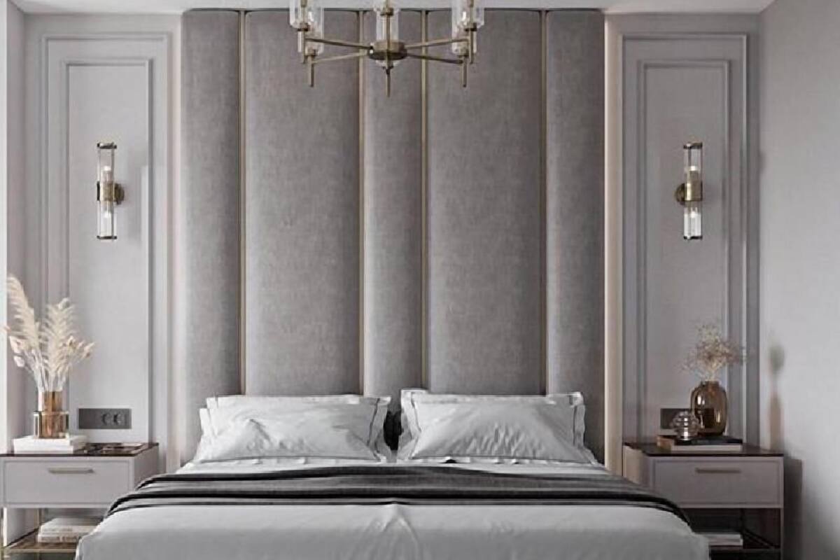 A modern bedroom with a large bed, a chandelier, and two bedside tables with lamps.