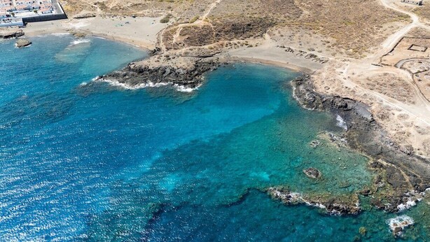 An aerial view of a coastal area with clear blue waters, rocky outcrops, and a sandy beach. - Home2Book Modern Bright Apt Abades, Pool & Terrace (Abades)