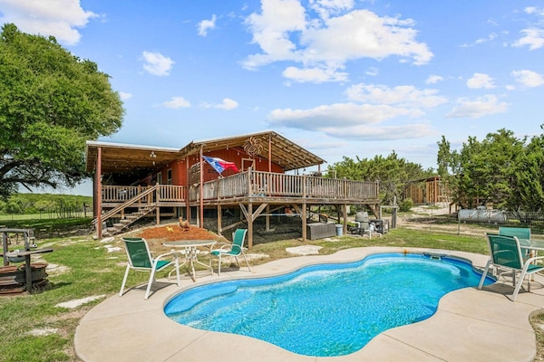 Relax on the spacious wrap-around porch and enjoy the stunning pool area, perfect for swimming or lounging. This outdoor space offers the ideal setting to unwind while enjoying the scenic surroundings.