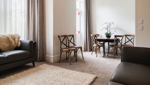 A living room with a sofa, a coffee table, and chairs.