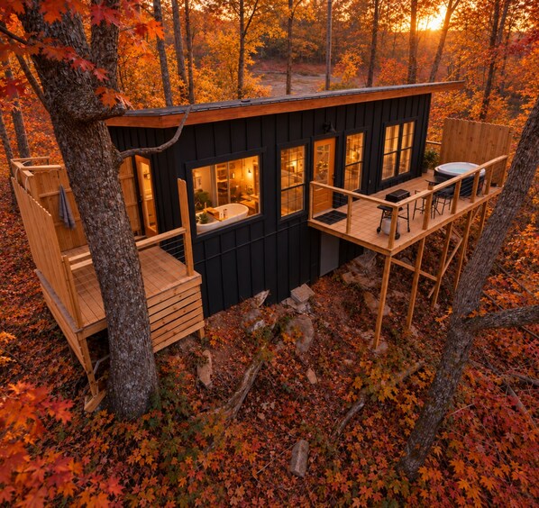 A cabin with a deck, a bathroom, and a dining area.