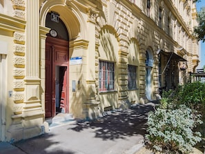 Experience the charm of this historic building with its classical facade, ornate details, and large windows.