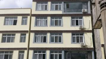 A multi-story building with multiple windows and balconies.