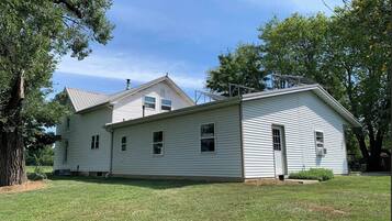 A single-story house with a gabled roof, a front porch, and a small front yard.