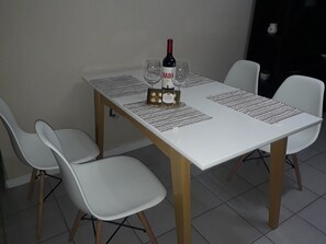 Enjoy a romantic meal for two in this elegant dining area, complete with a beautifully set table and comfortable seating.