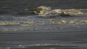 Ein Strand mit brechenden Wellen.