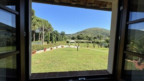 A view from a room with a large window overlooking a well-maintained lawn, a gazebo, and a hilly landscape. - House in Tuscany near Pisa & Lucca (Lucca)