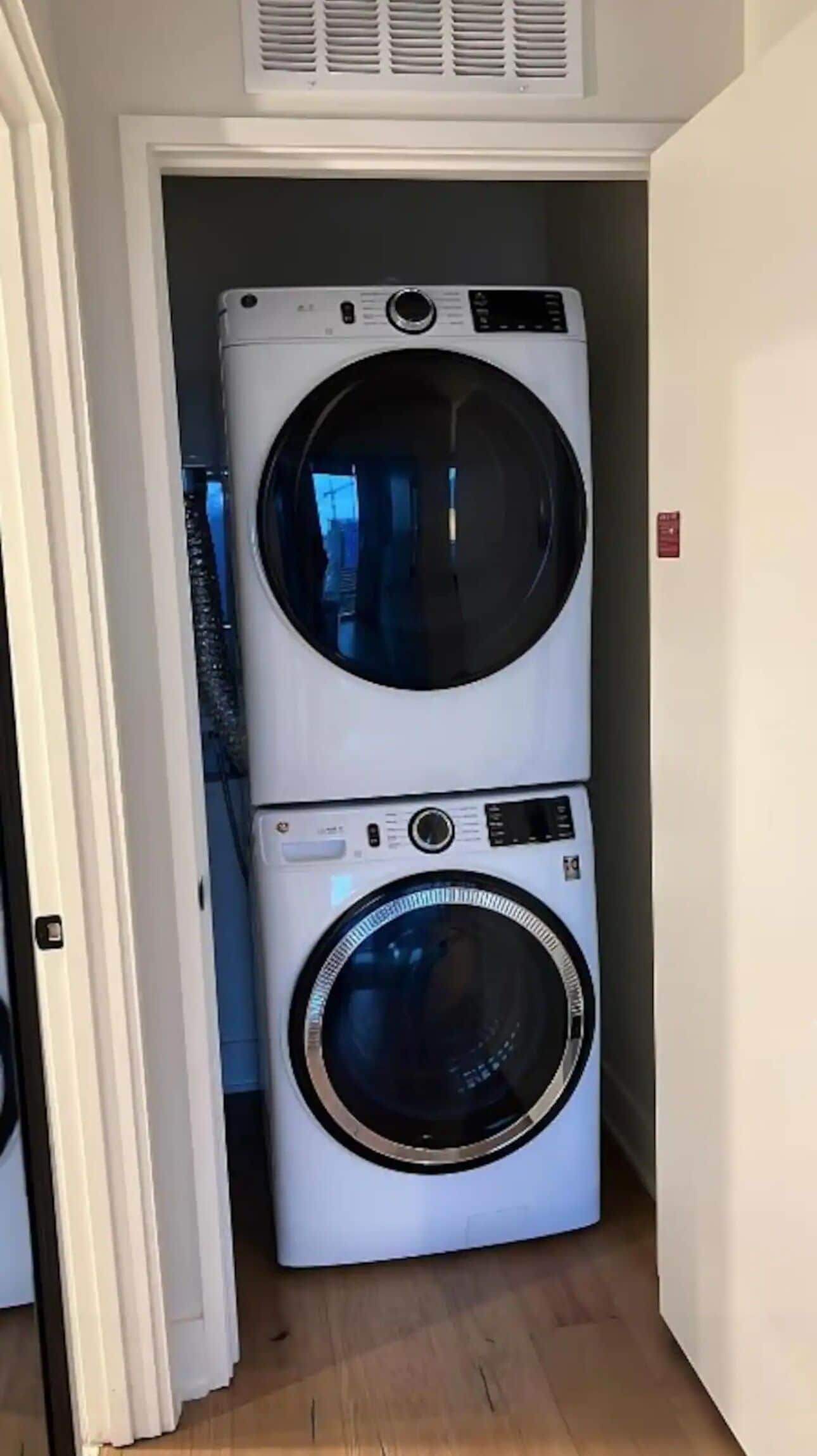 A laundry room with two stacked washing machines.