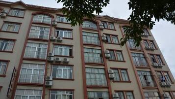 A multi-story building with numerous windows and balconies.