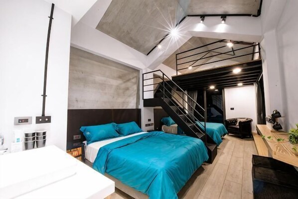 A modern bedroom with bunk beds, a desk, and a staircase. - Pathway Inn (Penghu)