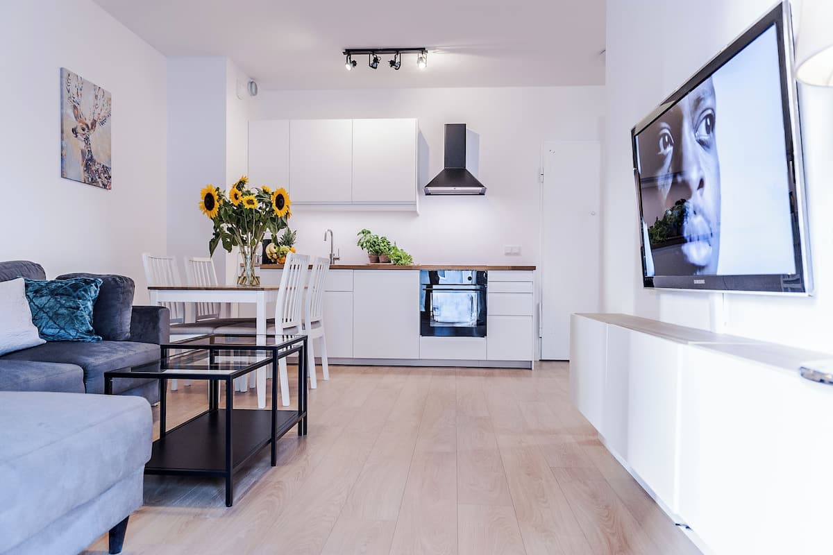 Relax in this stylish living space with a dining area, sofa, and integrated kitchen.