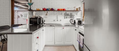 Fridge, coffee/tea maker, cookware/dishes/utensils