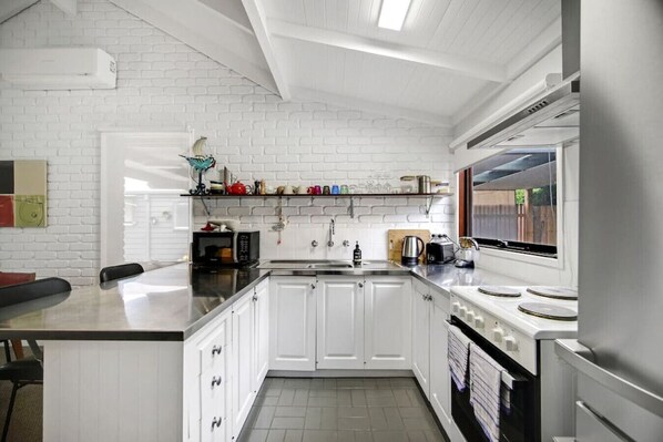 Fridge, coffee/tea maker, cookware/dishes/utensils