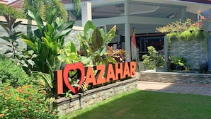 A hotel entrance with a large sign reading "I ♥ AZAHAR" surrounded by lush greenery and a modern building facade. - Azahar Resort Panglao powered by Cocotel (Panglao)