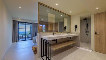 Une salle de bain moderne avec un grand miroir, deux vasques et une douche.