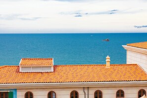 A coastal building with a tiled roof and arched windows. - Lotus Home Corner & Rooftop (Phu Quoc)