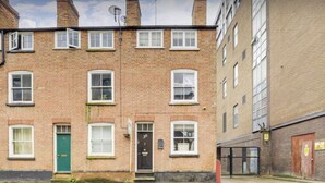 A two-story brick building with a green door, numbered 30, and a small front garden. - wellness studio Nottingham city centre (Nottingham)