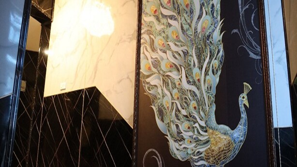 A staircase with a peacock mural on the wall. - Manopriya Residency by Azalea (Madurai)