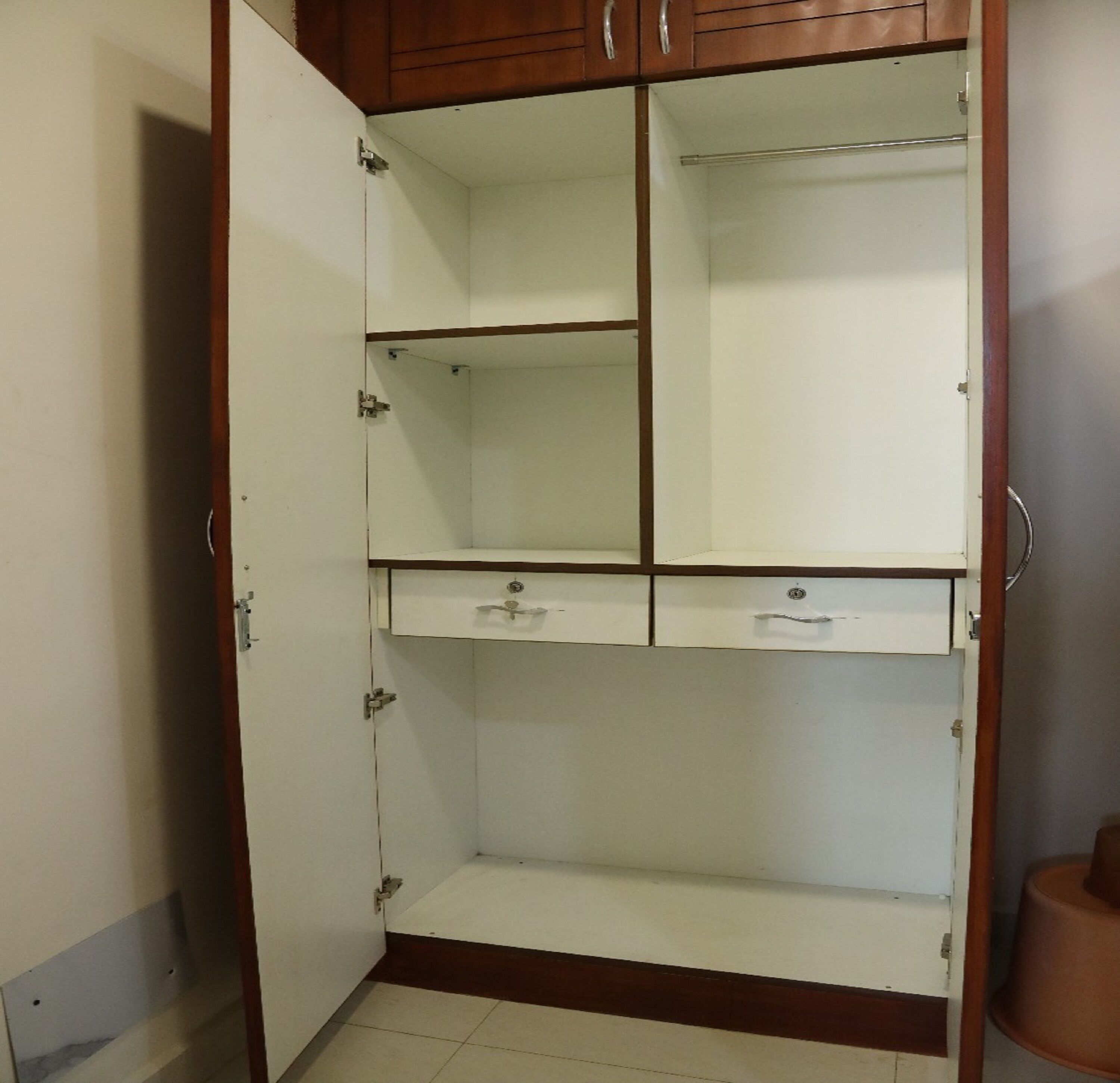 A wardrobe with multiple compartments, including hanging space and drawers.