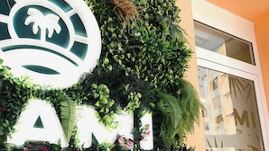 A building facade with a vertical garden and a sign that reads "ARTMELI Apartments." - Miami Apartments (St. Julian's)
