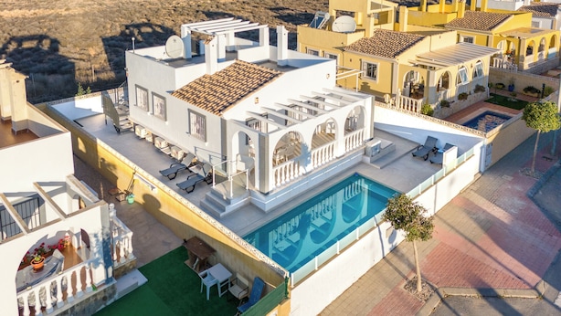 A modern hotel with a rooftop pool, outdoor seating, and a view of the surrounding landscape. - Luxurious Villa La Vita e Bella Escape in Murcia (Murcia)