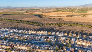 An aerial view of a town with a grid of buildings, roads, and agricultural fields. - Luxurious Villa La Vita e Bella Escape in Murcia (Murcia)