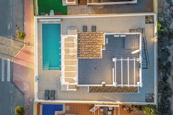 An aerial view of a hotel with a swimming pool, sun loungers, and a covered outdoor seating area. - Luxurious Villa La Vita e Bella Escape in Murcia (Murcia)