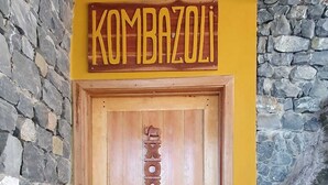 A wooden door with a yellow frame and a stone wall.