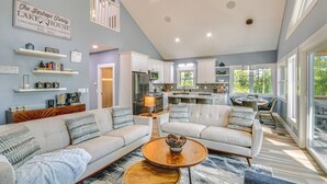 A spacious living room with a large sofa set, a coffee table, and a kitchen in the background. - Hot Tub + Game Room! Family Connelly Springs Home (Connellys Springs)