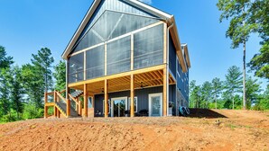 A modern two-story house with a large balcony, wooden deck, and a staircase leading to the upper floor. - Hot Tub + Game Room! Family Connelly Springs Home (Connellys Springs)