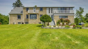 A two-story house with a well-maintained lawn, a small tree, and a stone pathway leading to the front door. - Pet-friendly New Berlin Retreat w/ Patio & Yard! (New Berlin)