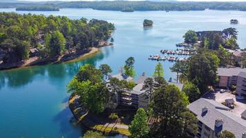 A lakeside property with a marina, multiple buildings, and surrounding greenery.