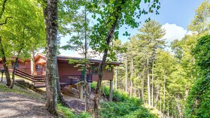 A cabin with a wooden exterior, surrounded by dense forest. - Bryson City Cabin in Smoky Mtn w/ Resort Amenities (Bryson City)