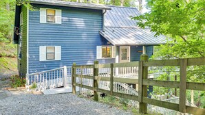 A two-story blue house with a wooden deck and a staircase leading to the second floor. - Lakefront Murphy Getaway w/ Deck, Dock & Kayaks! (Murphy)