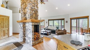 TV, fireplace, books - Home Near Glacier National Park w/ Hot Tub & Deck! (Columbia Falls)