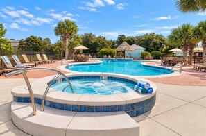 A pool area with a hot tub, lounge chairs, and umbrellas. - Sandy Pines Cottage | Private 3BR, 2 Pools + Beach Nearby (Gulf Shores)