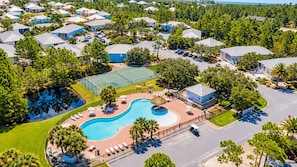 A residential area with multiple houses, a swimming pool, and a tennis court. - Sandy Pines Cottage | Private 3BR, 2 Pools + Beach Nearby (Gulf Shores)