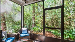 A room with a large window, wicker furniture, and a colorful rug. - 2Br/2.5Ba, 2 Pools, Tennis, Beach Access! + Free Attraction Tickets! (Santa Rosa Beach)