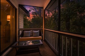A balcony with a cushioned seating area, a glass table, and a view of trees and sky. - 2Br/2.5Ba, 2 Pools, Tennis, Beach Access! + Free Attraction Tickets! (Santa Rosa Beach)