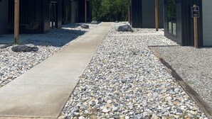 A row of modern, single-story buildings with a gravel pathway between them. - Lovely 2-bedroom cottage located in downtown Mount Vernon! (Mount Vernon)