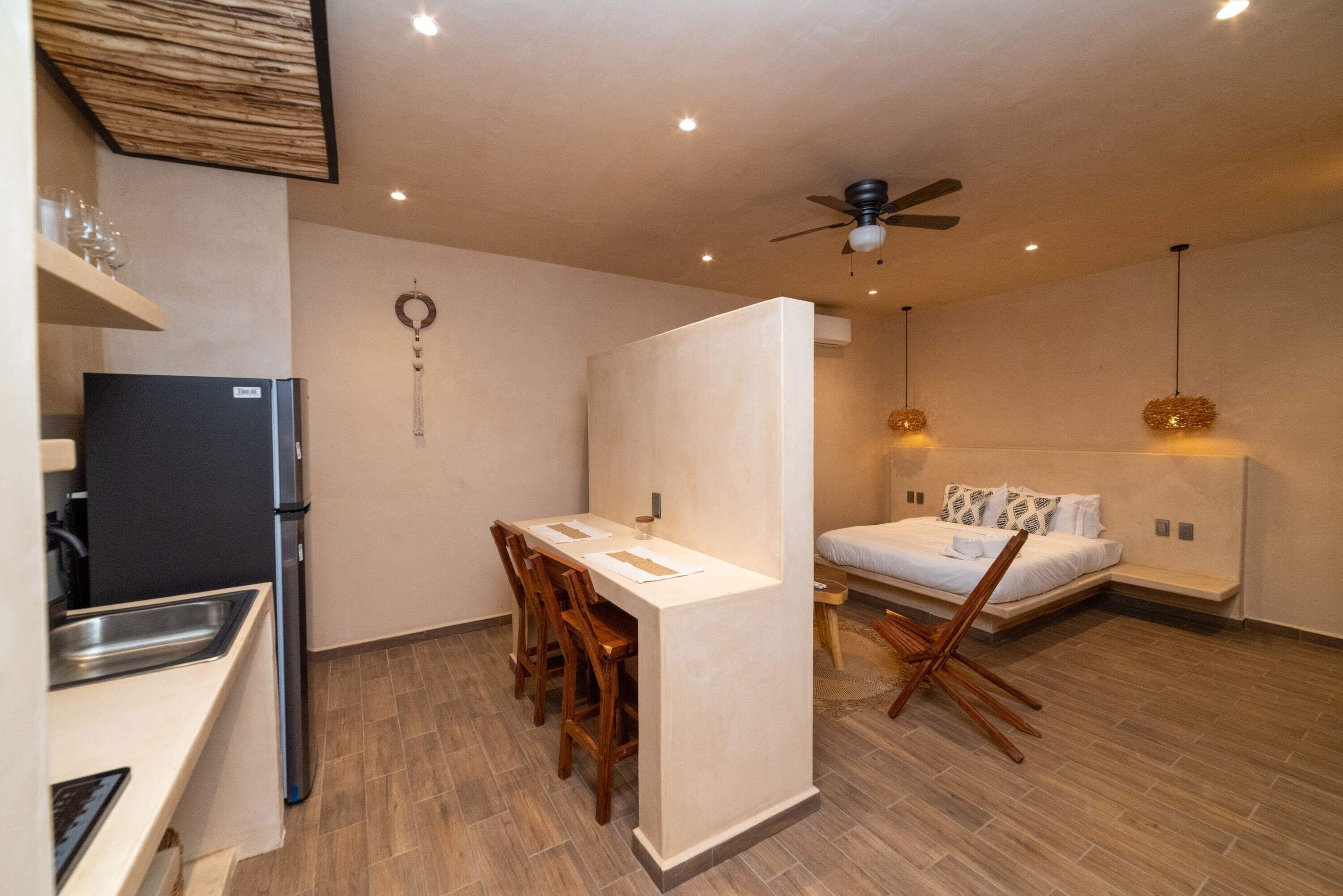 a kitchen with fridge and table in Tulum vacation rentals
