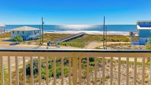 A coastal view with a beach, a pier, and two buildings. - Dream Chaser, Private Pool, Hot Tub, Pet Friendly (Eastpoint)