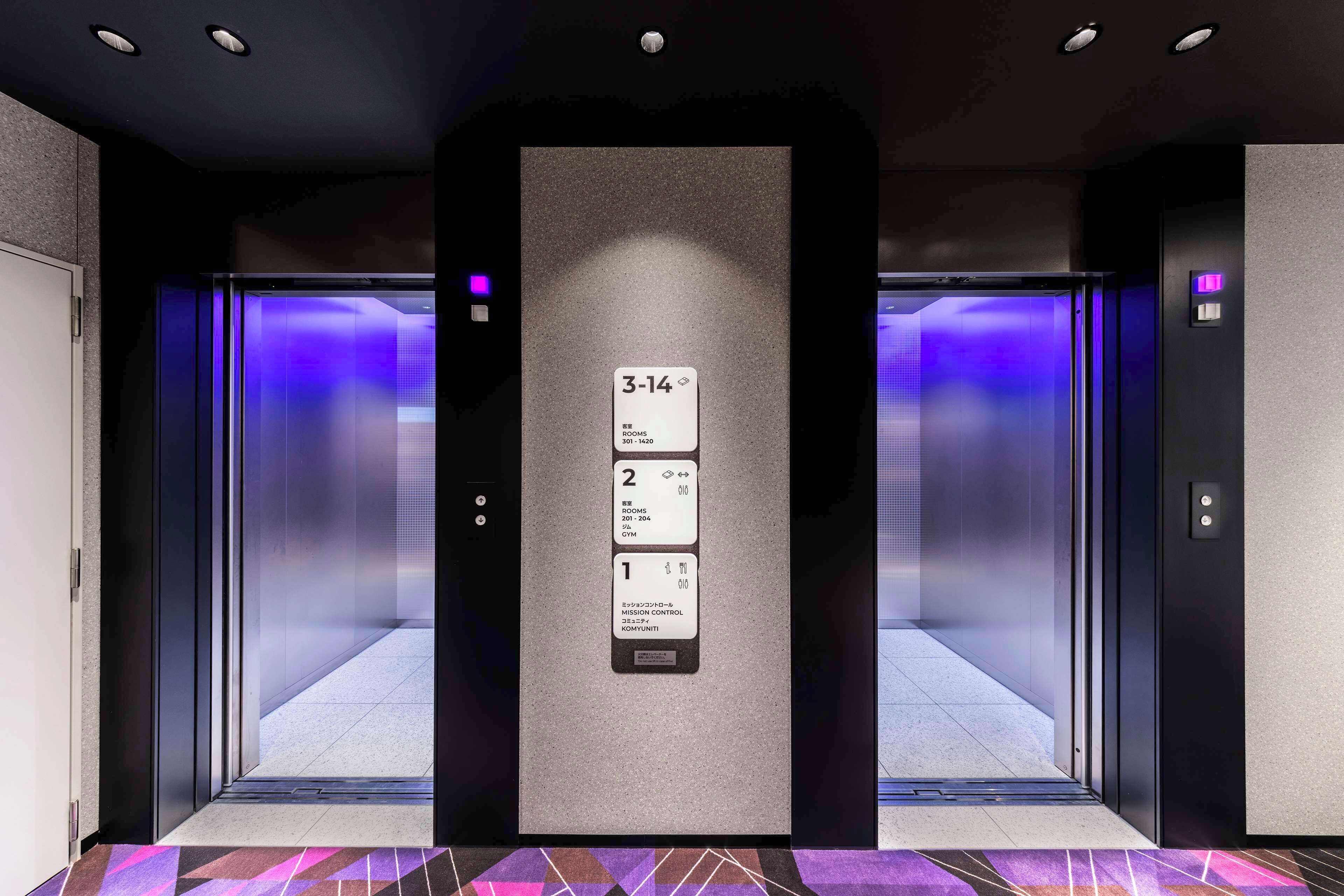 An elevator with a digital display showing floor numbers and room information.
