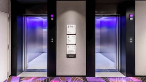 An elevator with a digital display showing floor numbers and room information. - YOTEL Tokyo Ginza (Tokyo)