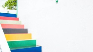 A staircase with colorful steps against a white wall. - LongXianJu Hotel (Shengsi)