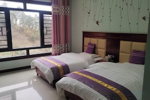 A bedroom with two beds, a window, and a view of the outdoors. - Hengyang Nanyueshan Xiangyuan Manor (Hengyang)