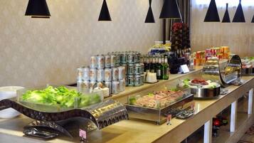A buffet with various food items and beverages.