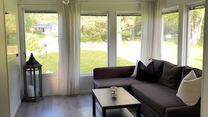 A modern living room with a sectional sofa, a coffee table, and a lantern.